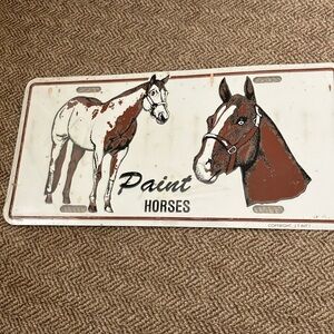 Paint horses, tin license plate